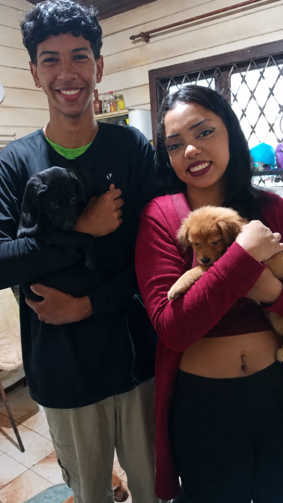 Casal segurando dois filhotes adotados